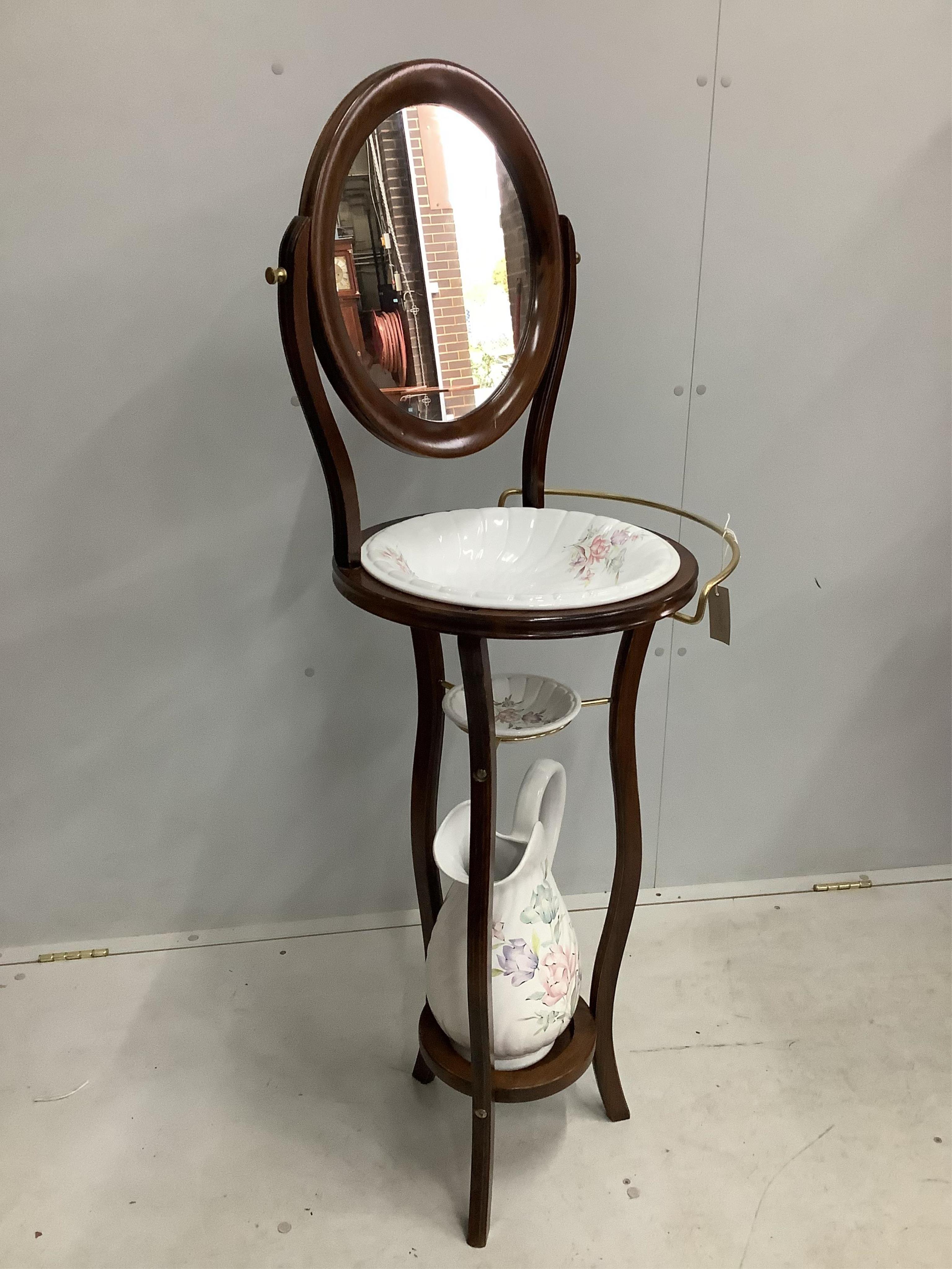 A modern Victorian style stained beech wash stand, with wash jug and basin, width 44cm, height 130cm Condition - good